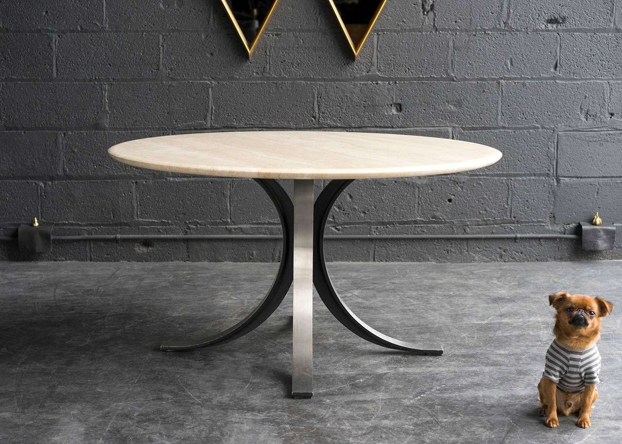 Here we have a nicely proportioned table which works comfortably with standard height dining chairs yet is slightly lower than a conventional height table. The base is constructed of heavy black metal with a stainless steel face. Cantilevered