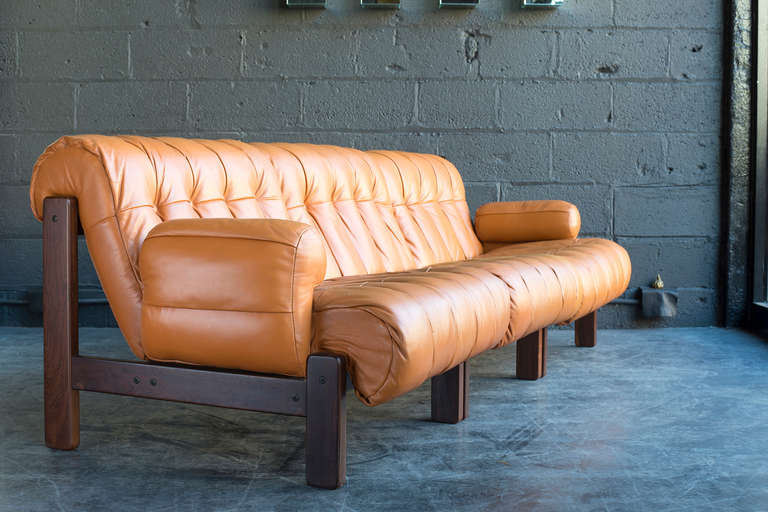 Solid jacaranda frames and original leather upholstery with nice aged patina.

This versatile set is comprised of 3 seats and 2 detachable arms. The arms may be attached to either side of any seat. 

Original Italma sticker.