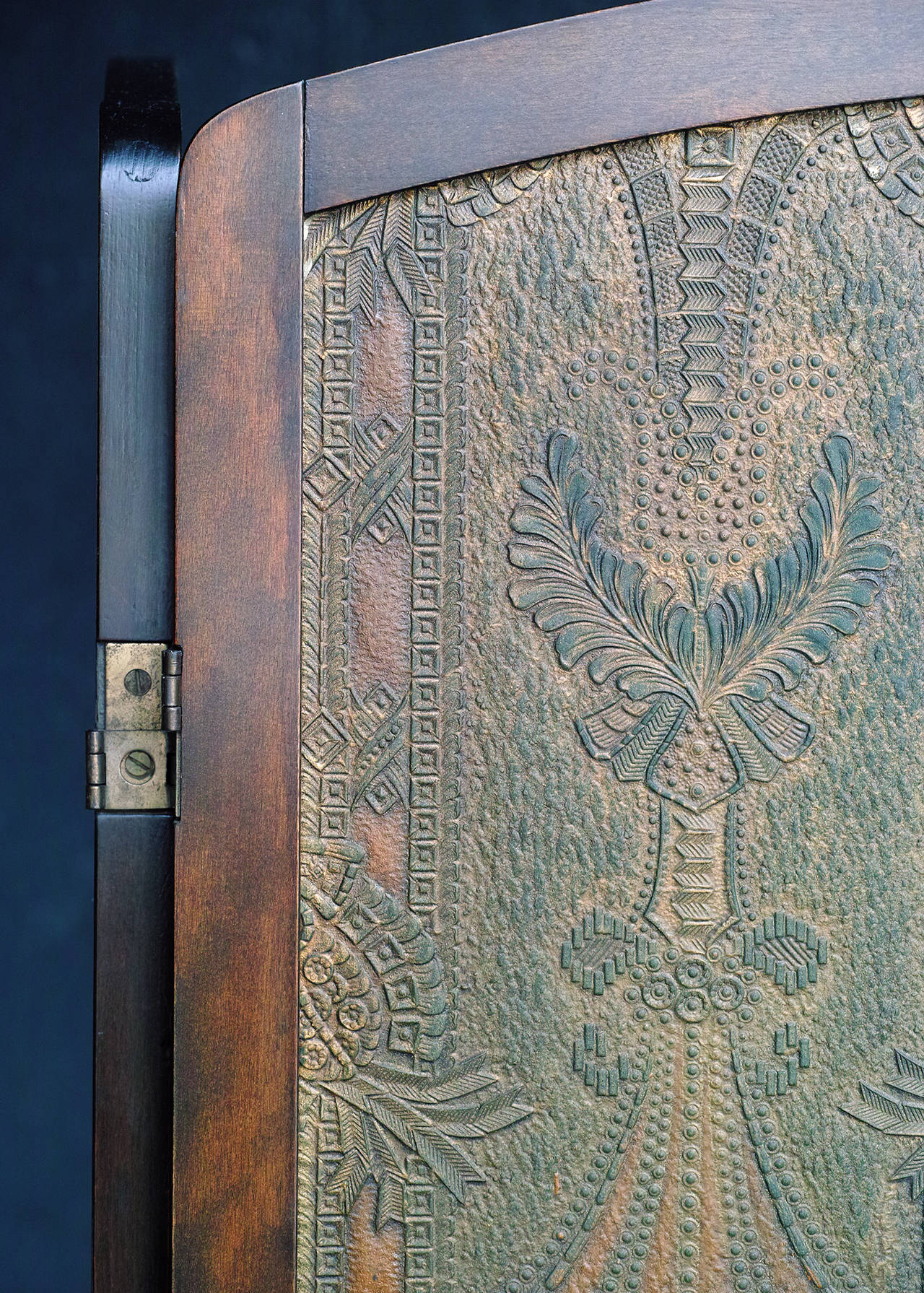 Embossed fiber board panels with hand tinted surface in predominately bronze and muted green tones. Arched wood frames. Hinges allow panels to be folded in either direction. Each panel is 22.25