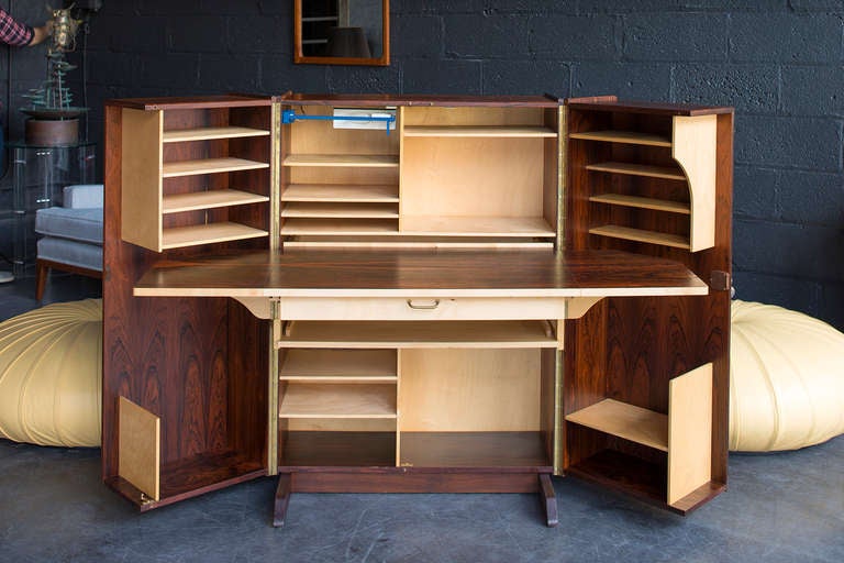 Brazilian rosewood & birch construction with 
piano hinge, built-in swivel task lamp,
multiple slots & cubbies, pencil drawer,
slide out lower tray, lock & 2 keys

very clean with minimal signs of wear