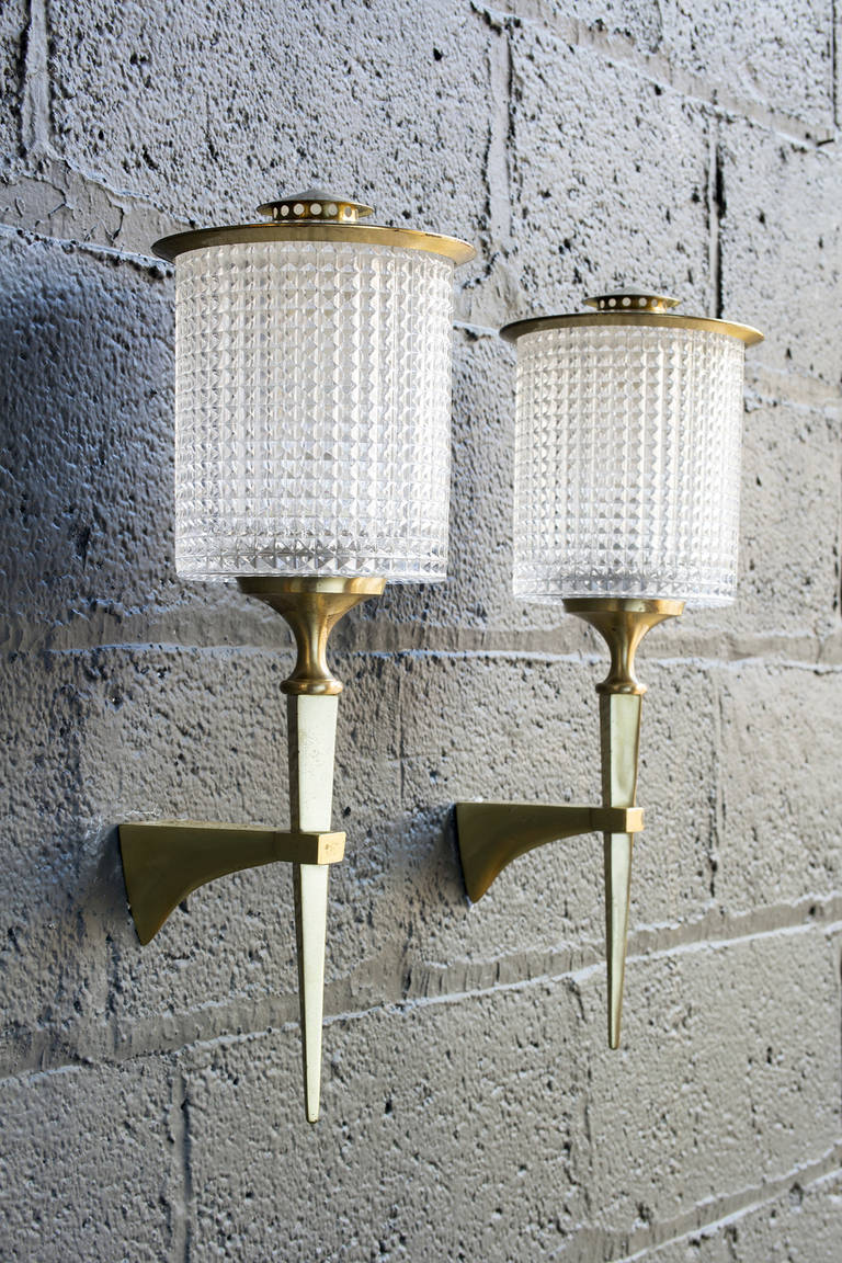 Elegant modern torch form with brass plated surface and faceted cylindrical glass shades.