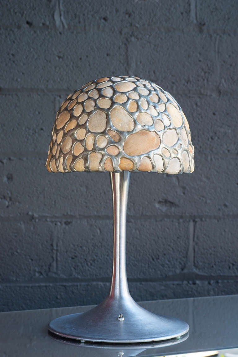 unusual lamp with a shade of whole, translucent stones set in metal

spun aluminum tulip base

porcelain socket