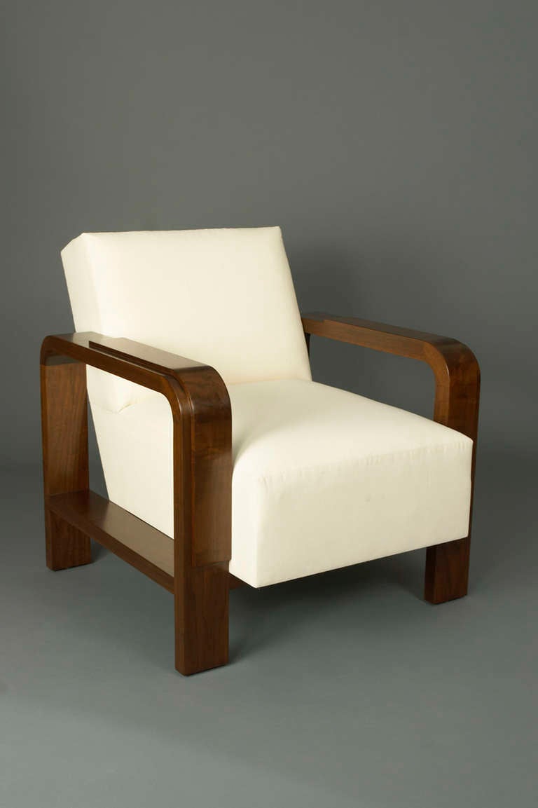 This is an armchair produced by Frank Rogin Inc. It is based on a Jacques Adnet armchair from 1929. Available in different woods and finishes.