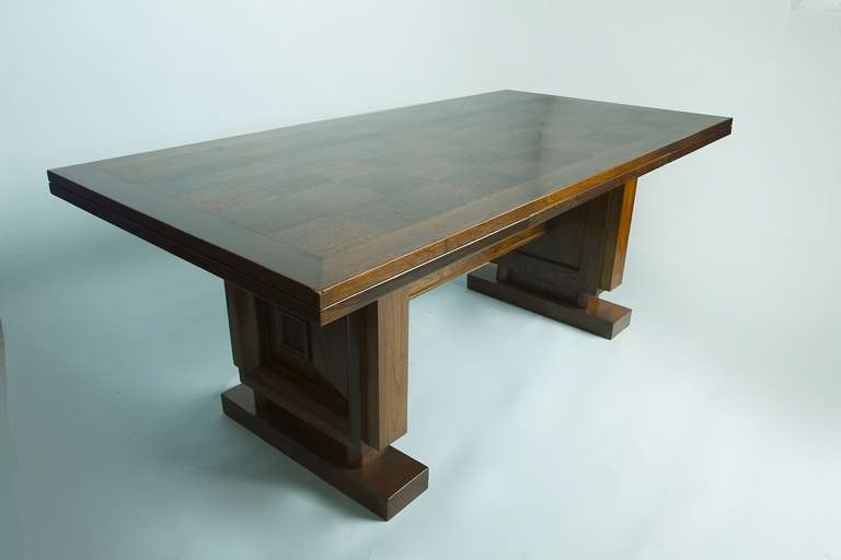 Massive table made of solid French oak with two leaves. The table is 119 inches when the leaves are included. Dudouyt was influenced by the Arts and Craft movement and Frank Loyd Wright.