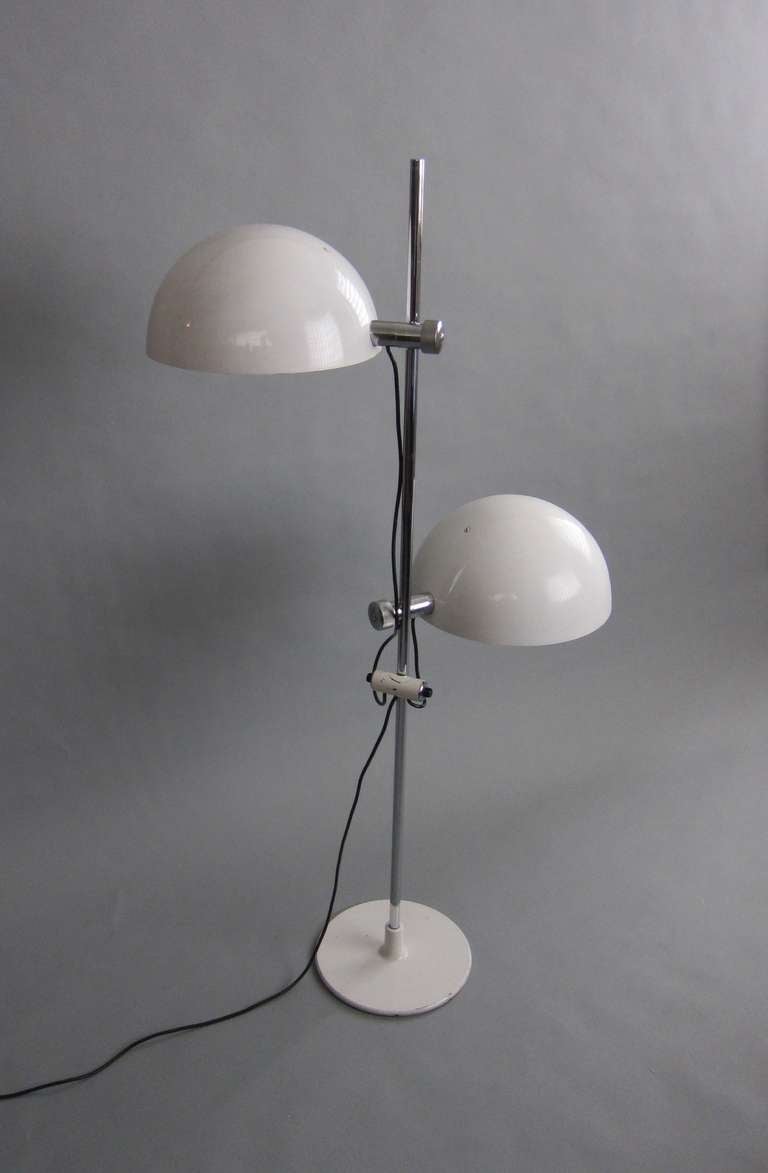 Adjustable globes that can move up and down . Globes can also be tilted.  The light was influenced by photographic studio lights. Original white enamel paint. All original parts.