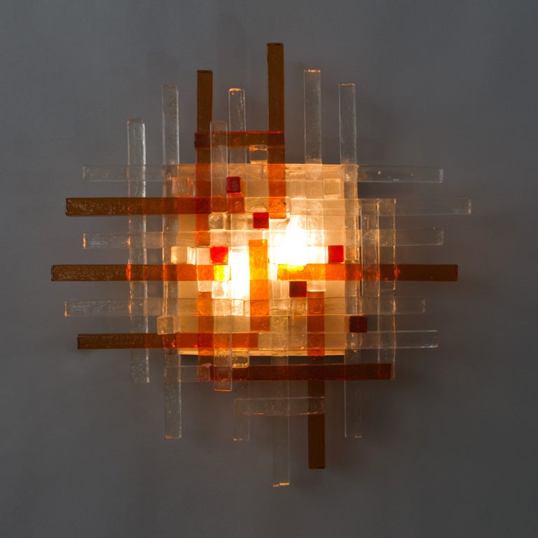 A single wall light of interlocking raw crystal rods. Two interior light bulbs.