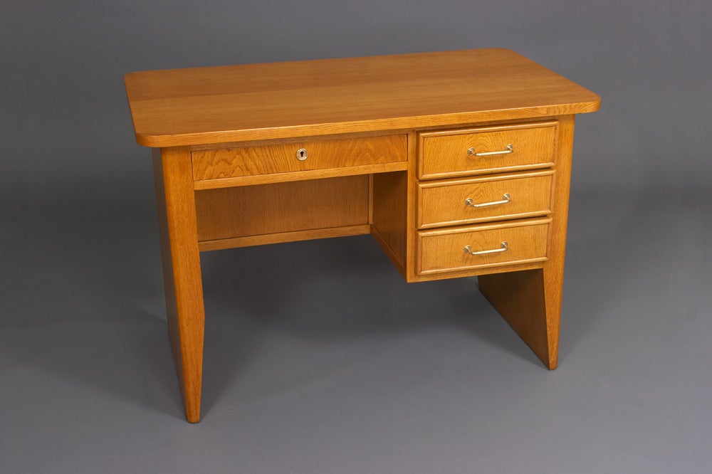 Post World War II oak desk with bronze drawer pulls.