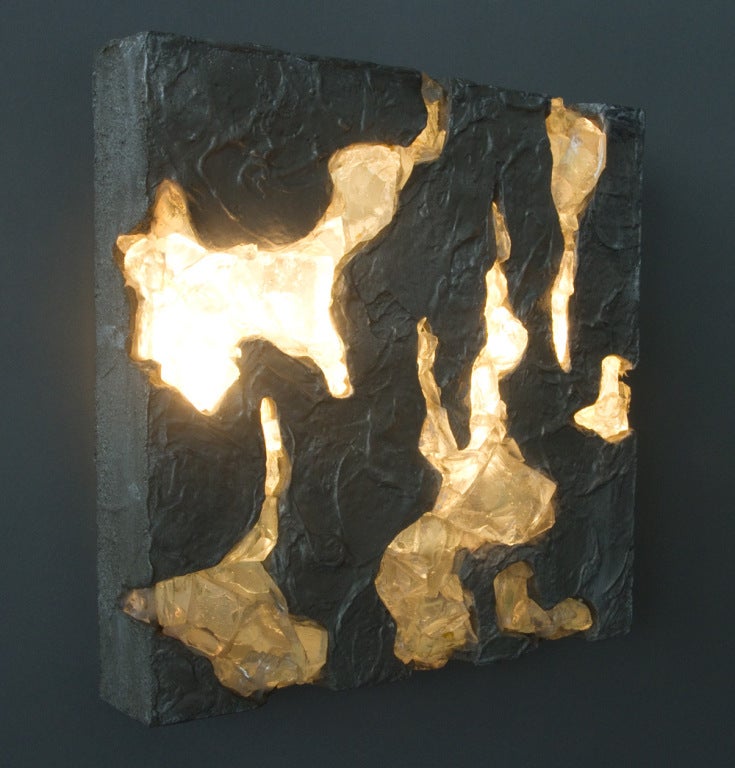 This wall light is made of small pieces of clear colored glass adhered to the cast aluminium base. There are two internal 25watt lightbulbs that illuminate the glass components from behind. The electrical plating has been re-wired.