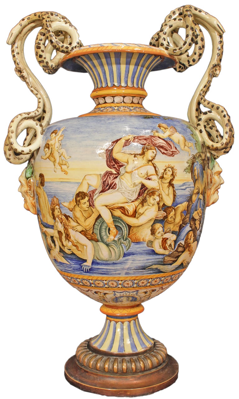 A very attractive and highly decorative Italian mid 19th century majolica vase. The vase is raised by a circular brass base below a reeded support. A fluted stem elevates the baluster shaped vase painted in blue and yellow. The body of the vase