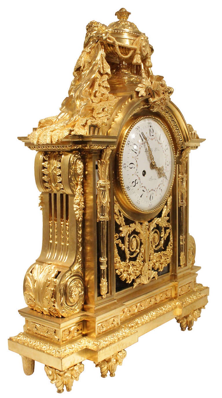 A sensational high quality French mid 19th century Louis XVI st. ormolu clock. Raised on eight feet with very unique spiral designs in the front adorned with rosettes. The finely chased frieze above with foliate borders is below the pierced   ormolu