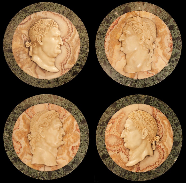 A very impressive set of four decorative 19th century Italian marble relief plaques. The alabaster wonderfully carved profiles of Roman Emperors, with their names engraved below, rest on solid Jaspe de Sicili marble supported on a thick circular