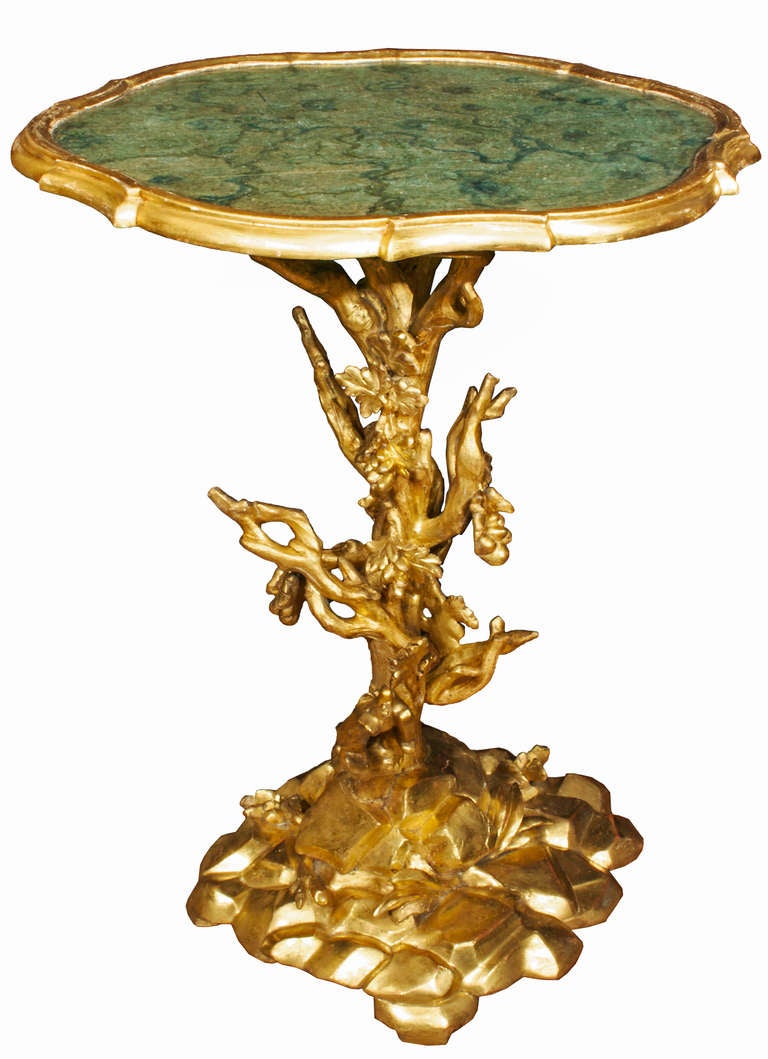 A very decorative Italian 19th century giltwood side table. The wonderfully carved giltwood sidetable resembling branches on a tree resting on large stones. The central fut is decorated with winding berried and foliate branches. Above is the