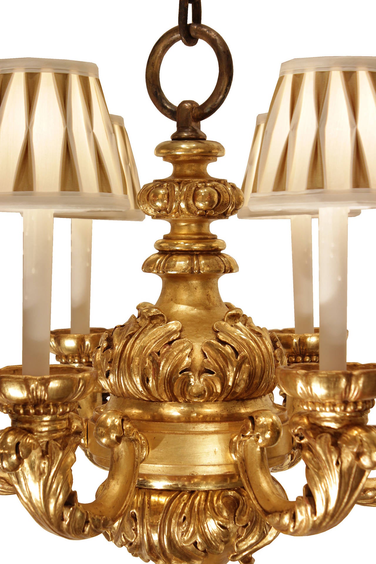 A striking pair of 19th century Italian inspired Louis XV style six-light giltwood chandeliers, stamped 'C' for Edward F Caldwell. Each chandelier is centered by a reeded bottom finial. The handsome central fut is decorated in a satin and burnished