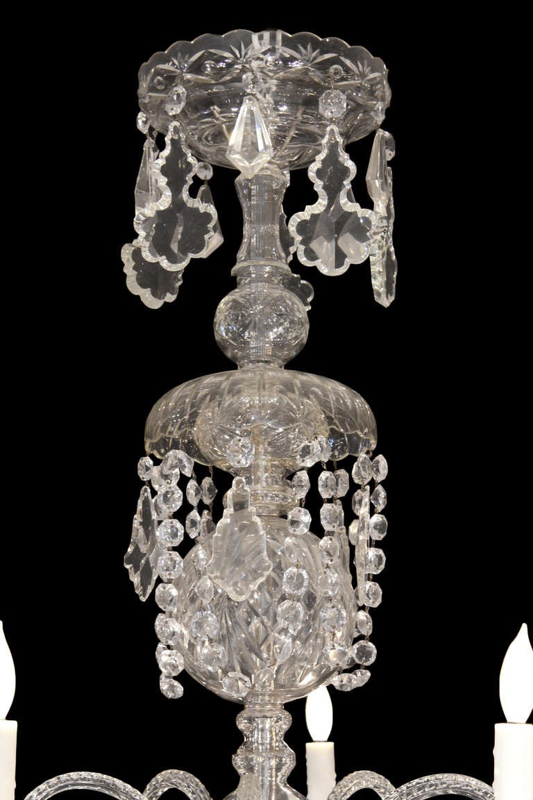 A stunning and most impressive pair of late 19th Century Waterford crystal and silver nineteen light chandeliers. A large crystal dish with detailed etching is holding up a tier of seven large and seven smaller sized twisted crystal arms with