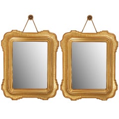 A pair of Italian mid 19th century burnished and satin giltwood mirrors