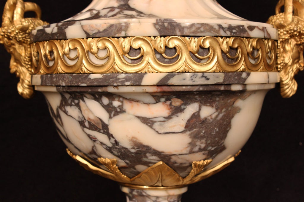 A pair of French mid 19th century Louis XVI marble urns