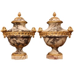 A pair of French mid 19th century Louis XVI marble urns