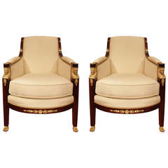 A pair of French 19th century Empire st. mahogany and ormolu arm chairs.