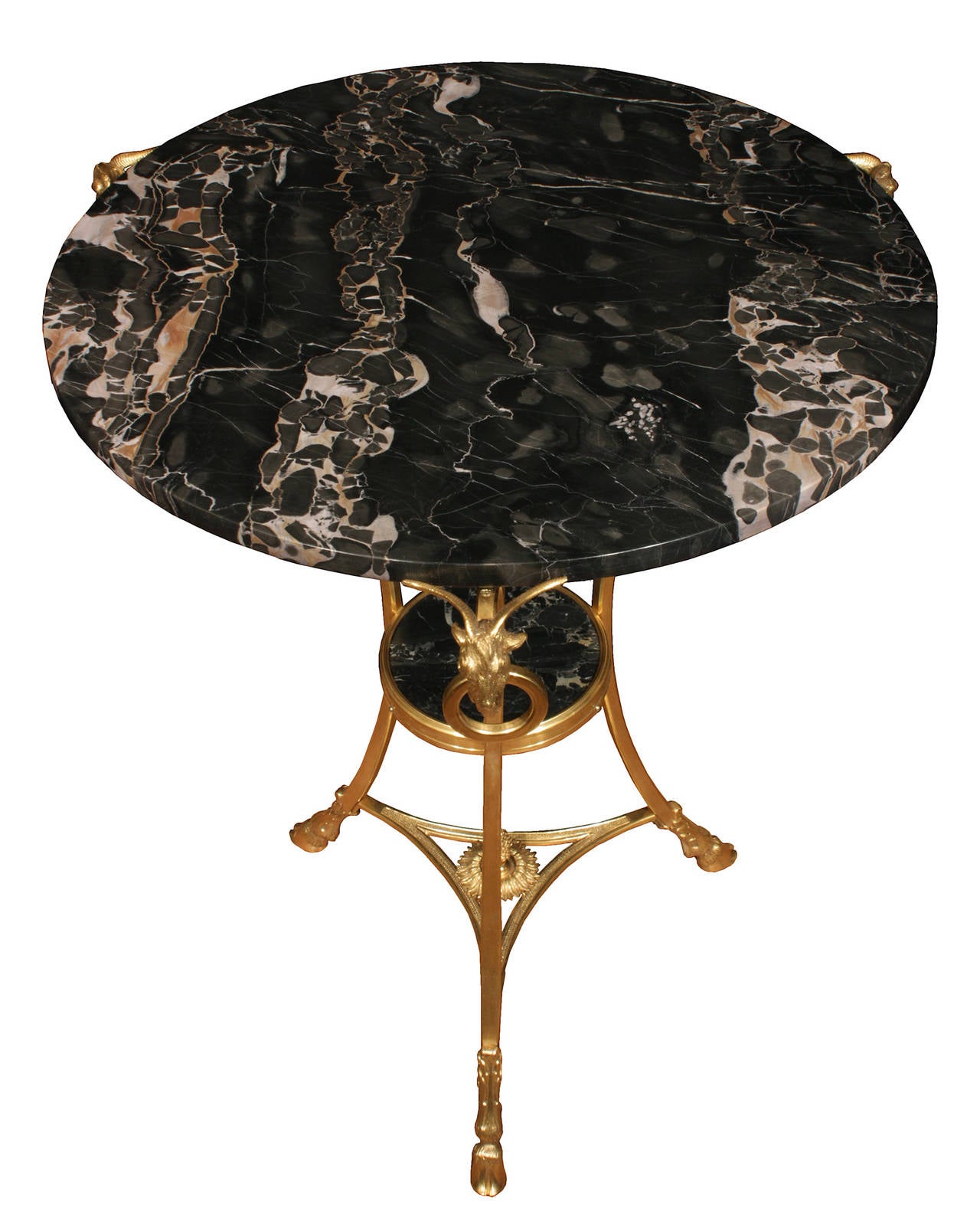 A striking pair of French 19th century Louis XVI style ormolu and marble guéridons. Each table is raised on an ormolu tripod base with handsome hoof feet and acanthus leaf chasing below C scrolled legs. The lower pierced triangular stretcher has