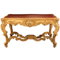 A Louis XIV st. Richly Carved Giltwood and Leather Center Table