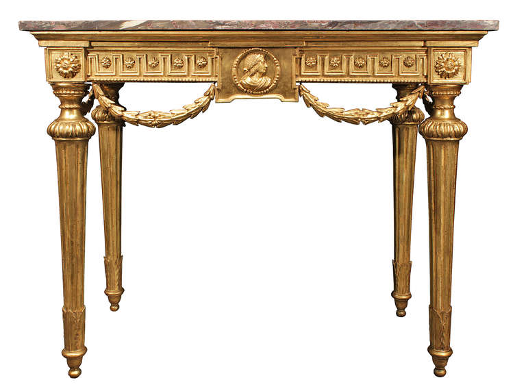 A very decorative mid 18th century Louis XVI period giltwood and marble console. The console is raised on tapered fluted legs with topie shaped feet and carved acanthus leaf and beaded top trim. The impressive frieze is decorated with a carved Greek