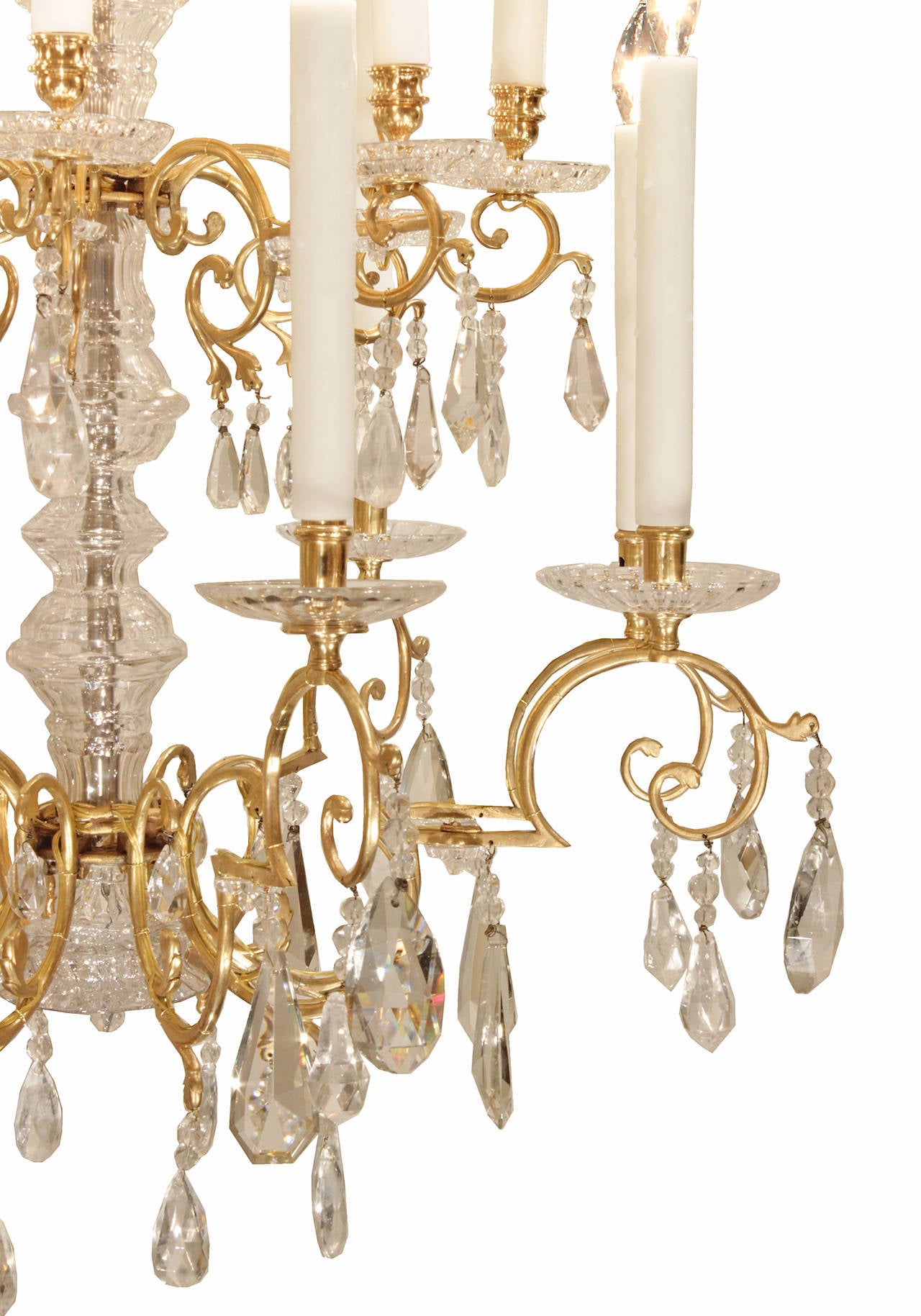 An elegant French 19th century Louis XVI st. sixteen light ormolu and all original Baccarat and rock crystal chandelier. The chandelier is centered by a bottom solid Baccarat crystal base surrounded by elegant cut crystal pendants. The arms, on two