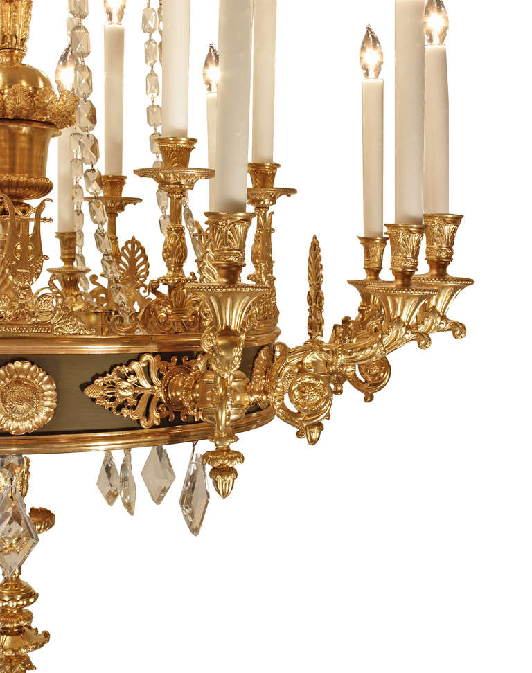 A spectacular French 19th century Neo-Classical st. eighteen light ormolu chandelier. The very impressive central fut has various stations of ormolu design elements with a bottom inverted berried finial and ormolu spray ending with kite shaped