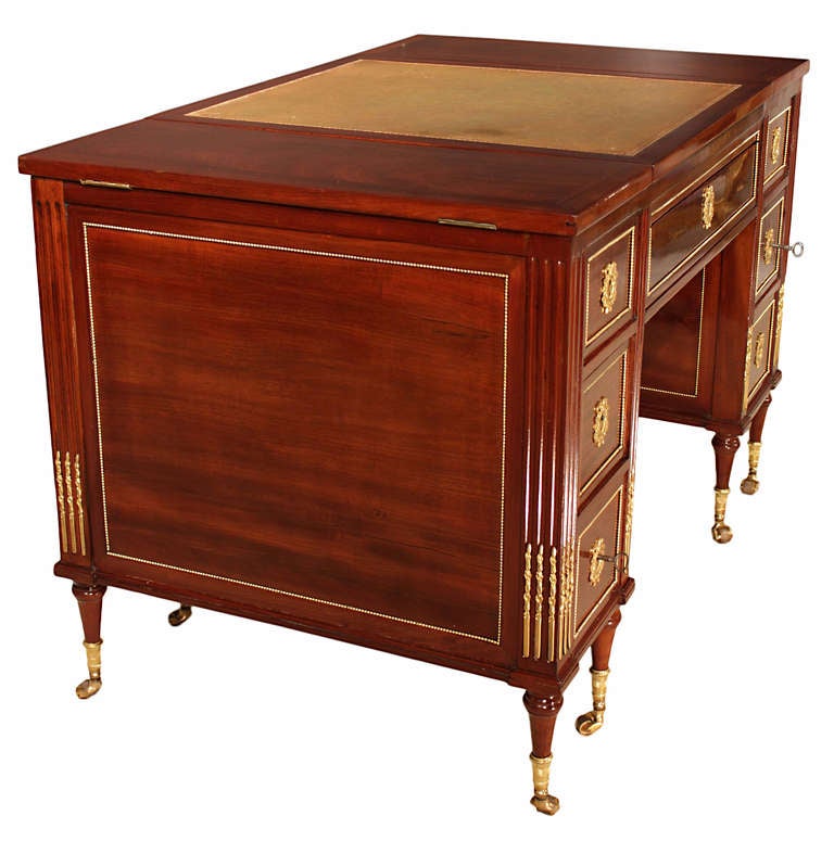 A magnificent and extremely high quality French 18th century 
Louis XVI period mahogany and ormolu vanity/desk. Raised on eight topie shaped legs with ormolu wrap around sabots and castors, below reeded inserts of ormolu chandelles on the façade