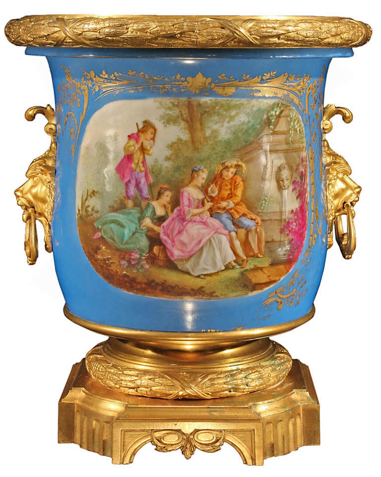 A spectacular and monumental French mid 19th century 
Louis XVI st. Sèvres and ormolu jardiniere. The urn is raised on an ormolu base with reeded arched sides below a finely chased tied wreath. Above is the magnificent hand painted and gilt Sèvres