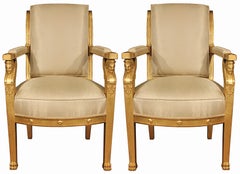 A pair of French First Empire period, ca 1805, giltwood armchairs