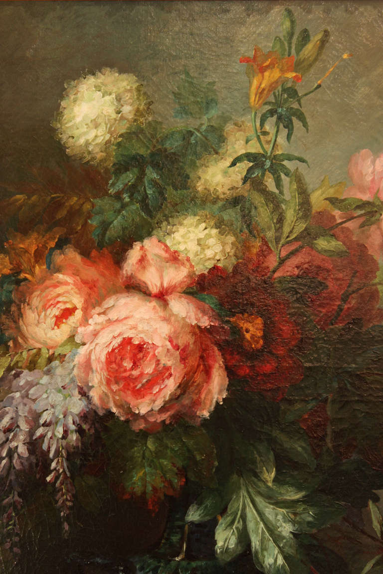 A beautiful and richly hued 19th century oil on canvas, signed A. Mertz.  The still life painting depicts a vase with an abundance of colorful flowers and foliate, all within a Louis XVI finely carved giltwood frame.