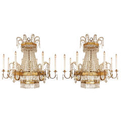 A pair of Italian 19th century gilt metal and crystal eight light chandeliers
