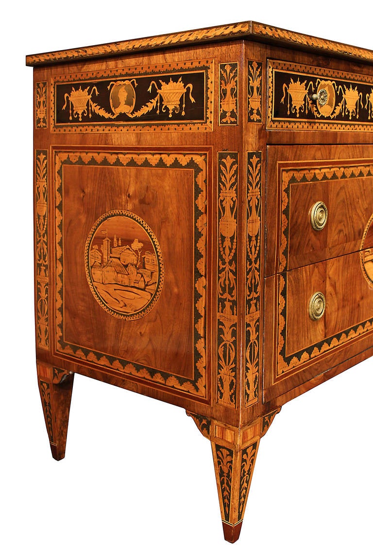 A handsome and very high quality Italian late 18th century Louis XVI period walnut and tulipwood chest, in the manner of Maggiolini. Raised on four square tapered legs with intricate marquetry design that is repeated along the two side columns