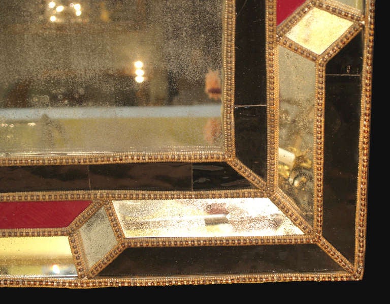 A pair of early 19th century Italian mirrors with red and dark blue glass