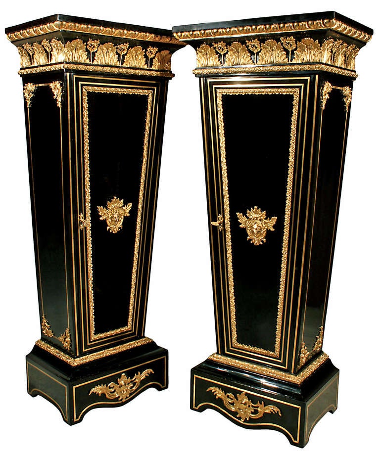 A spectacular and very high quality pair of mid 19th century French Louis XVI st. ebony, brass inlaid and ormolu mounted pedestals with rare front doors. The pair are raised by a rectangular base with brass fillets and have a central ormolu mount.