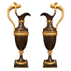 A pair of French 19th Century Directoire st. patinated bronze and ormolu ewers