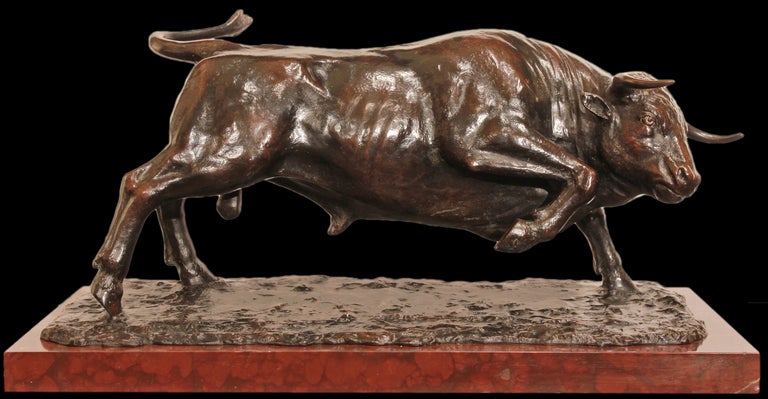 An impressive and highly decorative  French 19th century patinated bronze signed by R. Durquet. The bronze is raised by a rectangular Rouge Griotte marble base. Above lays a patinated bronze platform shaped as grass. On top stands a powerful bull