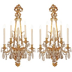 A pair of French mid 19th century Louis XVI st. ormolu and crystal sconces