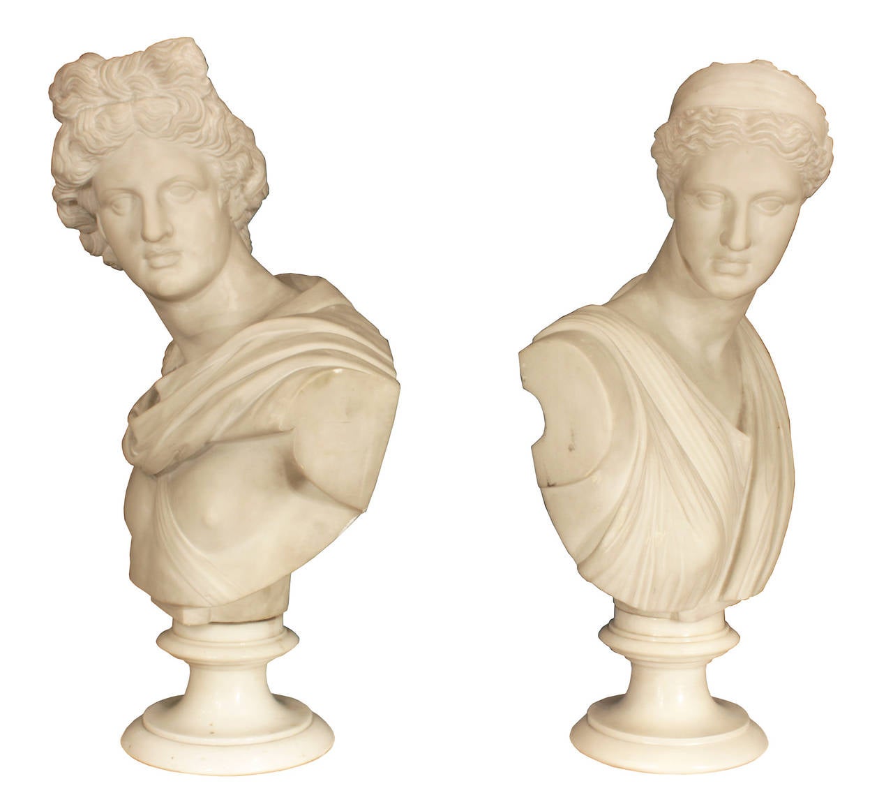 A high quality pair of Italian 19th century white Carrara marble busts of Apollo and Diana. Each bust is raised on a richly detail mottled socle. Apollo is dressed in a draped paludamentum fastened by a fibula, gazing at Diana. Diana in classical