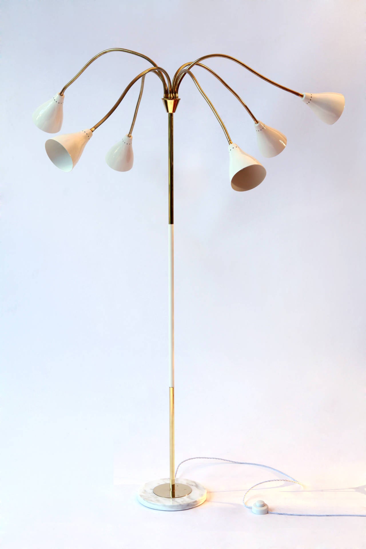 a large six adjustable arms floor lamp, model 1035 Arteluce by GINO SARFATTI 
reflectors in white lacquered aluminum on flexible arms in polished brass with a round marble base 
Produced in limited numbers and very rare this lamp exhibits the