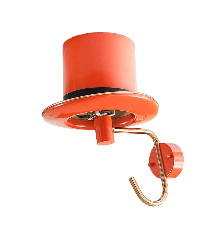 a pair of wall lights hats by Hans Agne Jakobsson, circa 1960. Manufactured by AB Markaryd Kungl Hovleverantor Denmark. Brass and laquered metal yellow and orange. Original label 
Measures: 40 x 32 xm 

Few lighting designers have left behind