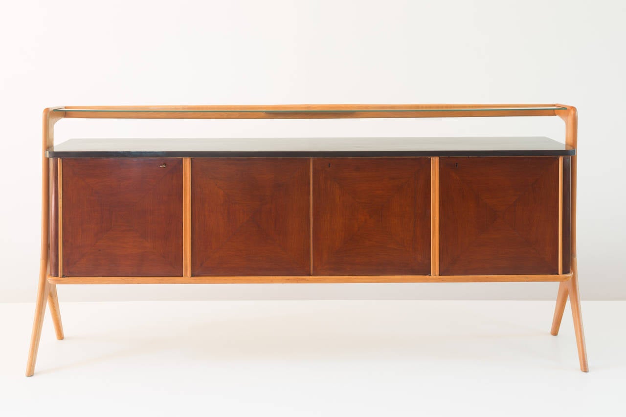 elegant and large sideboard designed by Vittorio Dassi, circa 1940 
maple wood, lacquered wood, brass and glass 
important details,floating glass console
brass joints,one key
all original condition 
Measures: h.103,5; 221,5 x 44,5