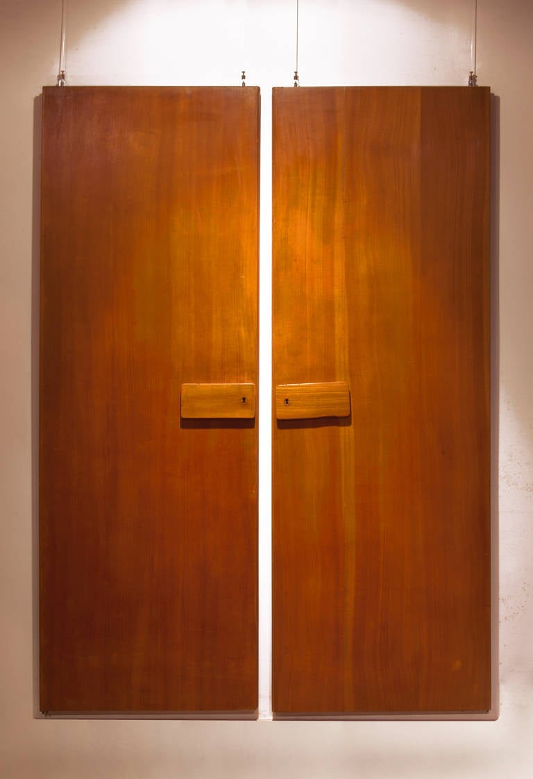 rare pair of GIO PONTI wardrobe doors,1955 
from the forniture of the Hotel Royal,Naples
mirrors on the verso 
walnut,brass details and mirrors 
Measures: 180cm , 63 x 3 cm (each) the handles:10 cm  21 x 3 cm  

Literature:Fabrizio Mautone