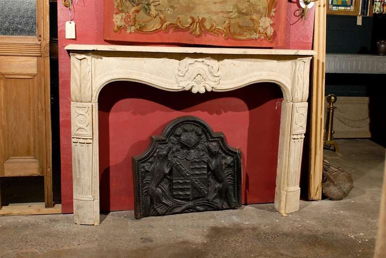 18th century French carved limestone mantel with exceptional details, circa 1720.  The apron includes a shell motif in the center and intricate carved details on the legs.

The interior opening measures:  51