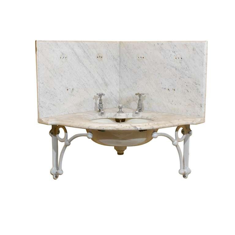 Lovely 19th century English marble corner sink with marble back splash, nickel fixtures and drain.  The corner sink is supported by two white enamelled iron brackets.  <br />
<br />
