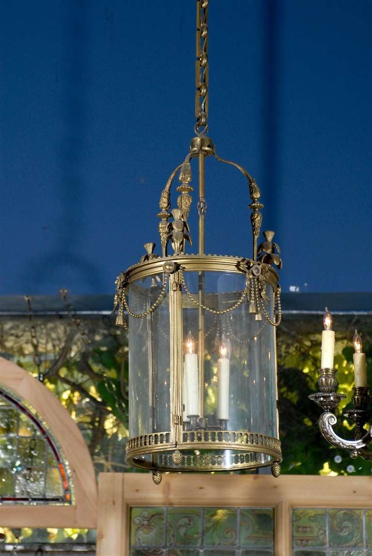 Classic 19th century French cylindrical brass hall lantern with caged triple candelabra. circa 1890.  Together with an additional 3 feet of chain and a canopy.<br />
<br />
UL Listed.<br />
<br />
