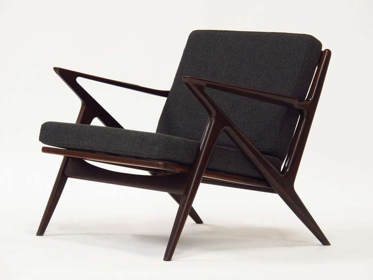 Lounge chair designed by Poul Jensen for Selig. Features a rosewood stained sculpted beech frame with newly upholstered dark-grey wool cushions supported by new rubber straps.