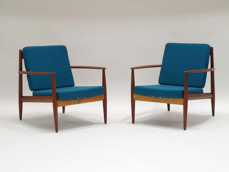 Pair of teak frame lounge chairs designed by Grete Jalk for France and Sons, Denmark. Newly upholstered in teal wool textile. Fabric swatches available upon request.