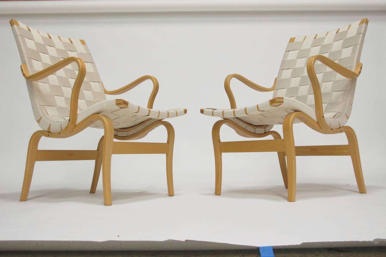 Bruno Mathsson Eva chairs crafted of solid birch frame and laminated beech with original canvas webbing.