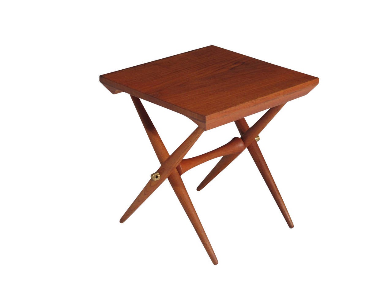 Jens Harald Quistgaard soild-teak "x" base occasional table. Ribbed brass fittings connect the turned stretcher and legs. Stamped with manufacturers mark "JHQ".